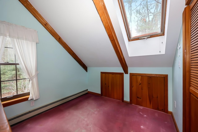 additional living space with lofted ceiling with skylight, carpet floors, and a baseboard radiator