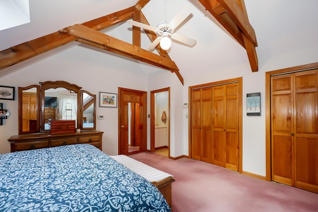 carpeted bedroom with beam ceiling, high vaulted ceiling, ceiling fan, and multiple closets