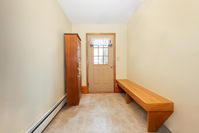 doorway to outside with a baseboard heating unit