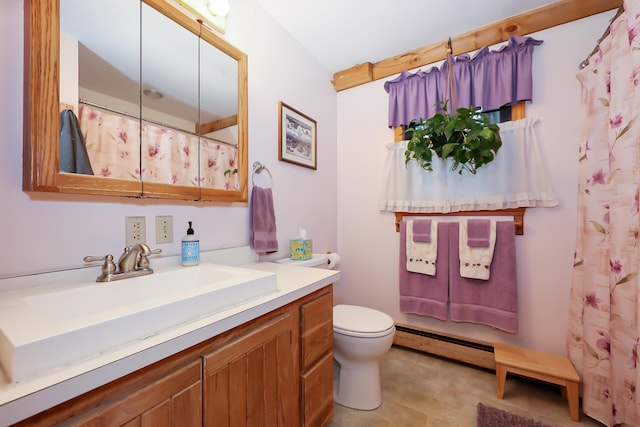 bathroom with vanity, toilet, and a baseboard heating unit