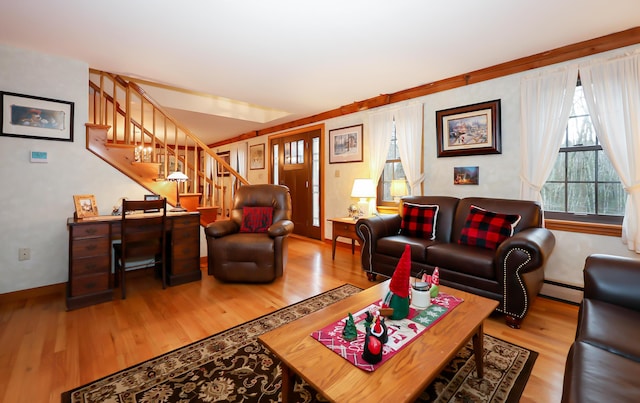 living room featuring baseboard heating and hardwood / wood-style flooring