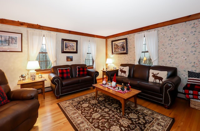 living room featuring crown molding, light hardwood / wood-style flooring, and plenty of natural light