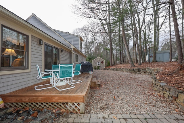 view of patio / terrace featuring grilling area, a storage shed, and a wooden deck