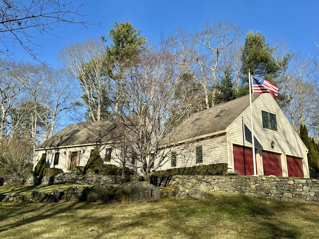 view of home's exterior featuring a garage and a lawn