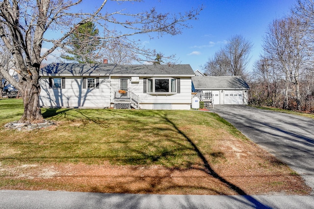 view of front of property featuring a garage and a front lawn