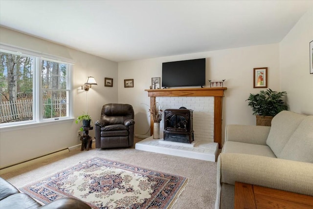 living room featuring carpet, a wood stove, and a baseboard heating unit