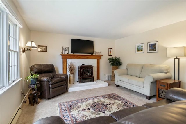 carpeted living room with baseboard heating and a wood stove