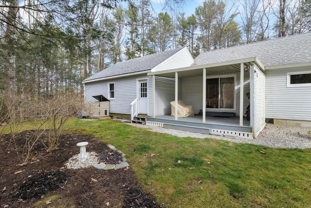 rear view of house featuring a yard