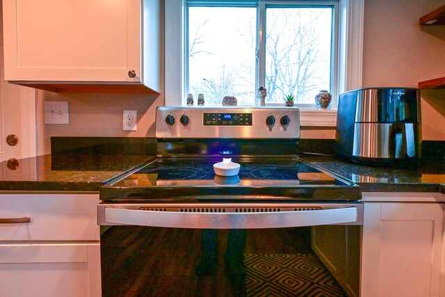 kitchen featuring stainless steel electric range oven and white cabinetry