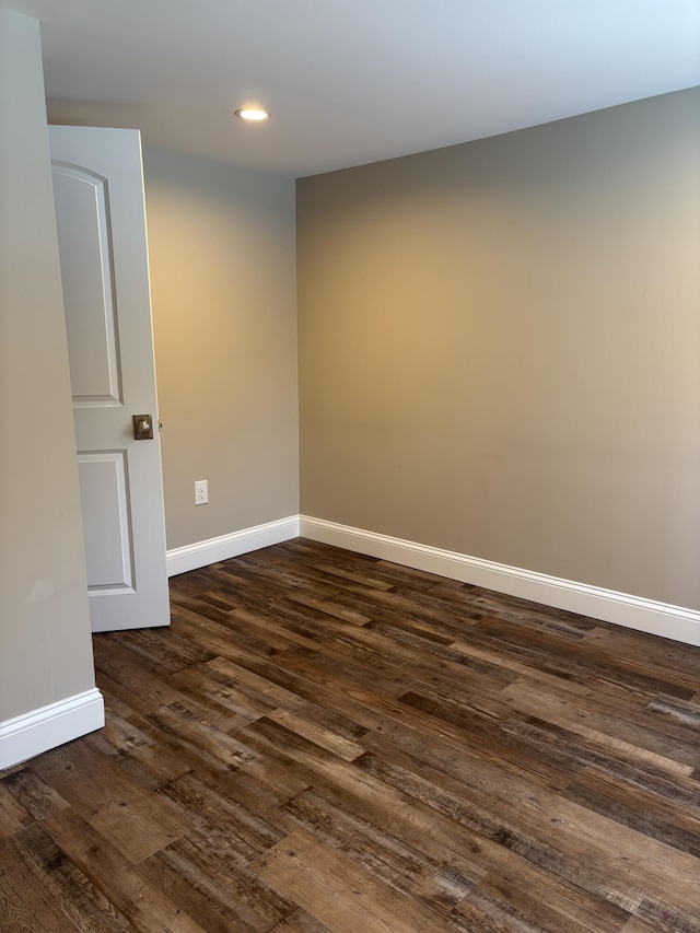 unfurnished room featuring dark wood-style flooring, recessed lighting, and baseboards