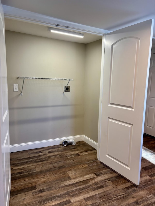 washroom with laundry area, dark wood-type flooring, and baseboards