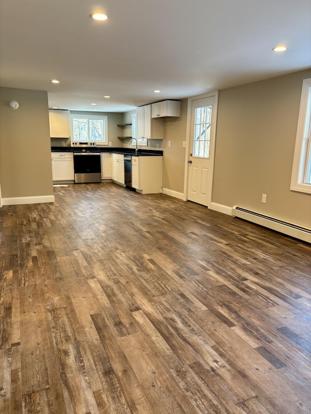 kitchen with baseboards, electric stove, dishwasher, dark countertops, and dark wood-type flooring