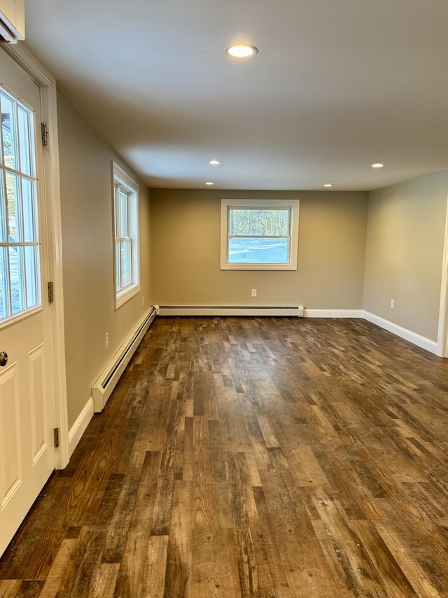 spare room with dark wood-style floors, a baseboard radiator, baseboards, and recessed lighting