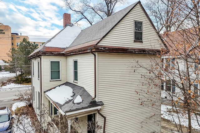 363 Broadway, Bangor, ME 04401 - view of snowy exterior with a chimney