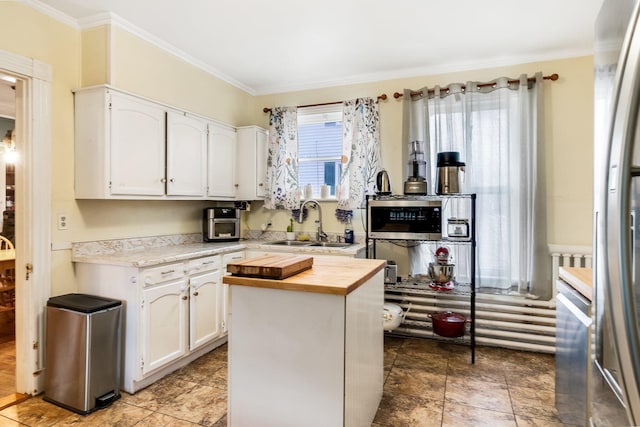 363 Broadway, Bangor, ME 04401 - kitchen with wood counters, a sink, white cabinetry, crown molding, and a kitchen island