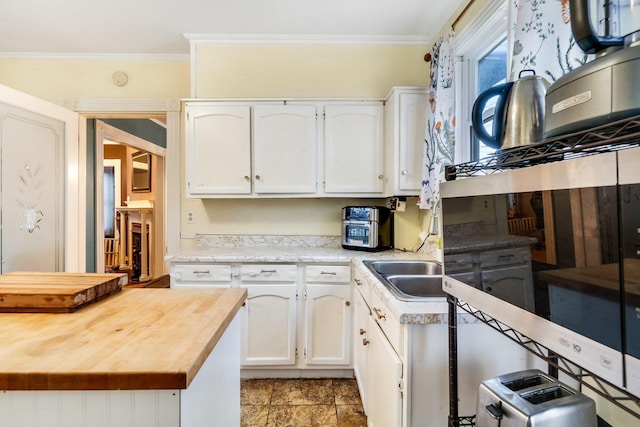 363 Broadway, Bangor, ME 04401 - kitchen featuring wooden counters, white cabinets, and crown molding