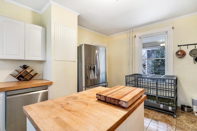 363 Broadway, Bangor, ME 04401 - kitchen featuring wooden counters, appliances with stainless steel finishes, crown molding, white cabinets, and tile patterned floors