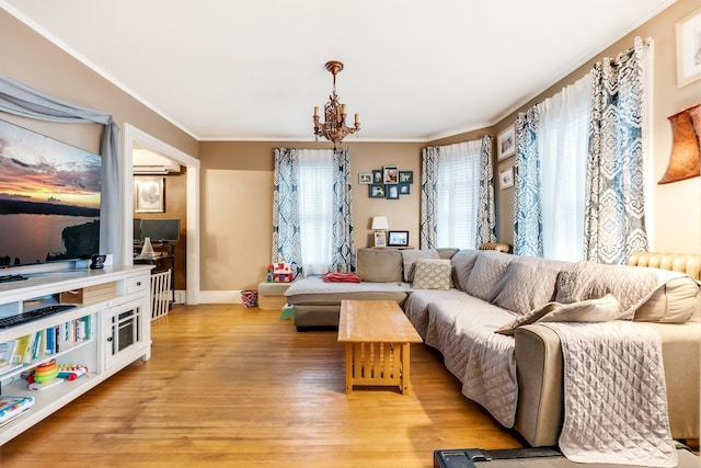 363 Broadway, Bangor, ME 04401 - living room with crown molding, light wood finished floors, a chandelier, and baseboards