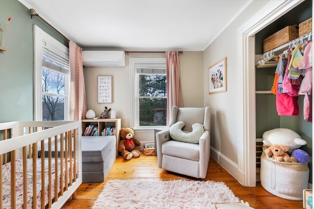 363 Broadway, Bangor, ME 04401 - bedroom with a wall mounted air conditioner, a nursery area, hardwood / wood-style flooring, multiple windows, and ornamental molding
