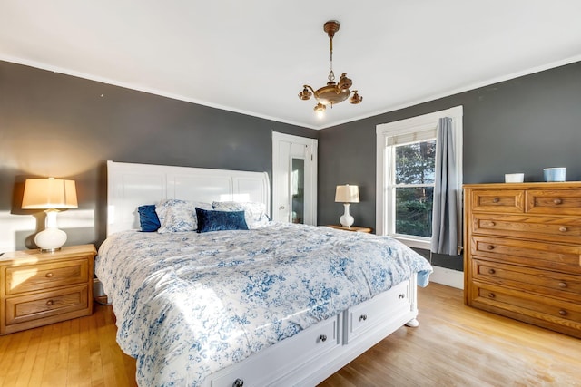 363 Broadway, Bangor, ME 04401 - bedroom with light wood-type flooring, a chandelier, and ornamental molding