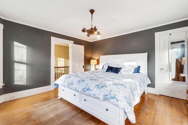 363 Broadway, Bangor, ME 04401 - bedroom with light wood-style flooring, baseboards, a chandelier, multiple windows, and ornamental molding