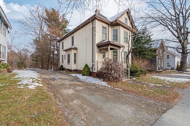 363 Broadway, Bangor, ME 04401 - snow covered property with a chimney and driveway
