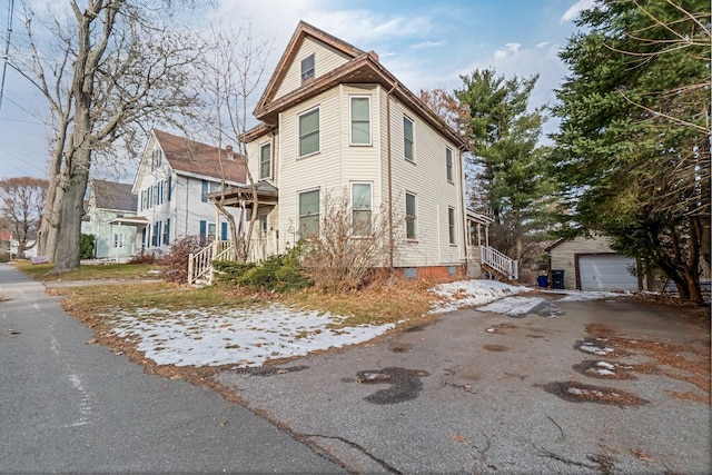 363 Broadway, Bangor, ME 04401 - view of side of property with an outbuilding, asphalt driveway, and a garage
