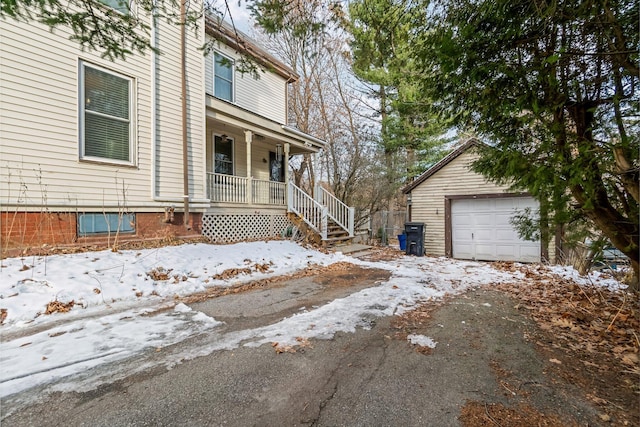363 Broadway, Bangor, ME 04401 - view of snowy exterior with covered porch, an outbuilding, and asphalt driveway