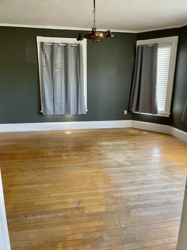 363 Broadway, Bangor, ME 04401 - unfurnished room featuring baseboards, hardwood / wood-style flooring, crown molding, and a chandelier