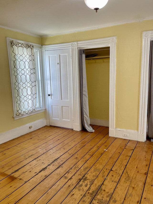 363 Broadway, Bangor, ME 04401 - unfurnished bedroom with light wood finished floors, ornamental molding, baseboards, and a closet