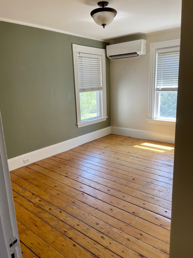 363 Broadway, Bangor, ME 04401 - empty room featuring a wall mounted AC, baseboards, healthy amount of natural light, and crown molding