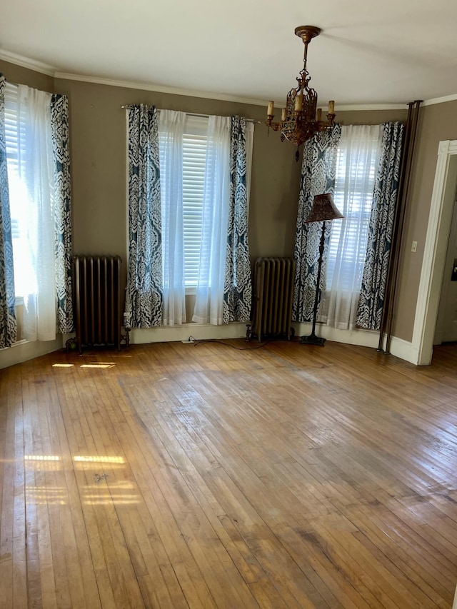 363 Broadway, Bangor, ME 04401 - unfurnished dining area featuring radiator, a chandelier, plenty of natural light, and crown molding