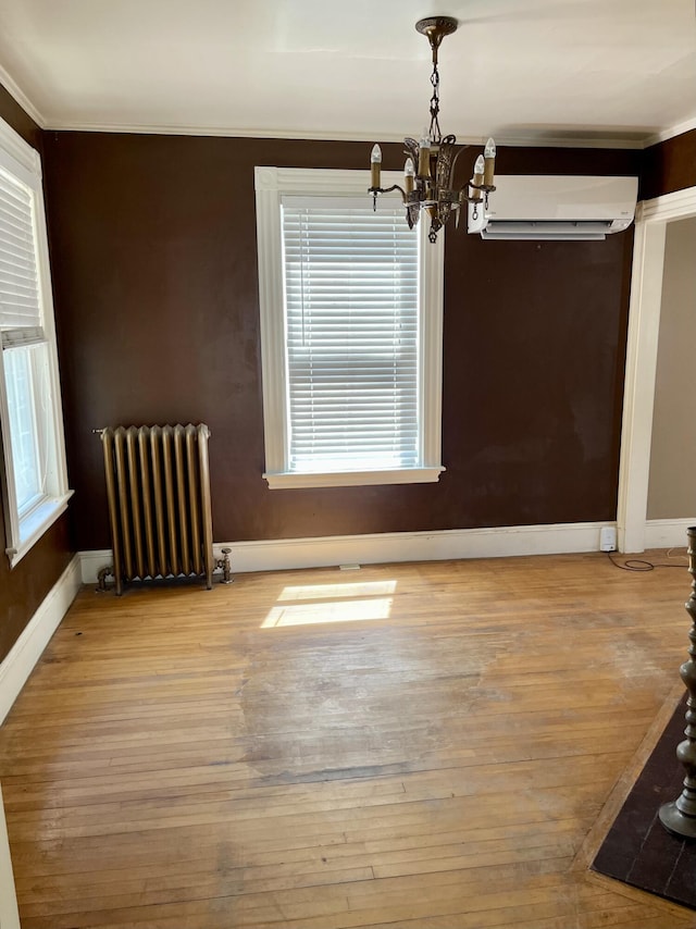 363 Broadway, Bangor, ME 04401 - unfurnished dining area featuring radiator, a chandelier, wood finished floors, ornamental molding, and baseboards