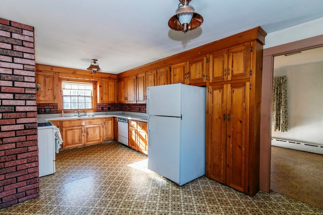 kitchen with decorative backsplash, white appliances, sink, and baseboard heating