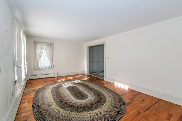 interior space with hardwood / wood-style floors and a baseboard radiator