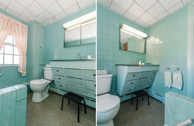 bathroom with toilet and tile walls