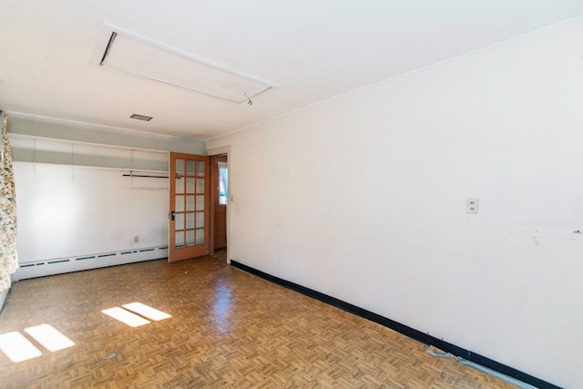 unfurnished room with baseboard heating and light parquet flooring