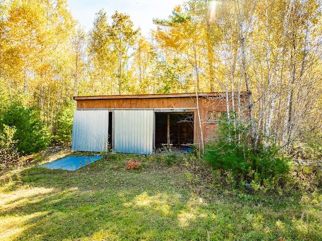 view of outbuilding featuring a yard