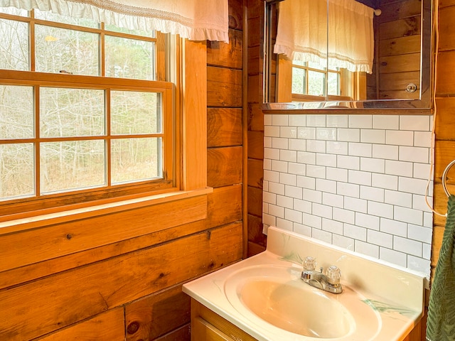 bathroom with wood walls and vanity