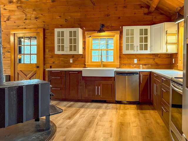 kitchen featuring white cabinets, appliances with stainless steel finishes, light hardwood / wood-style floors, and a healthy amount of sunlight