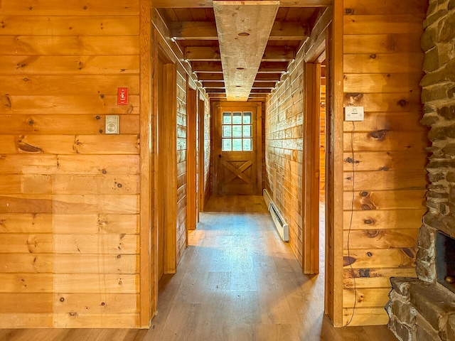 corridor with baseboard heating and light hardwood / wood-style flooring