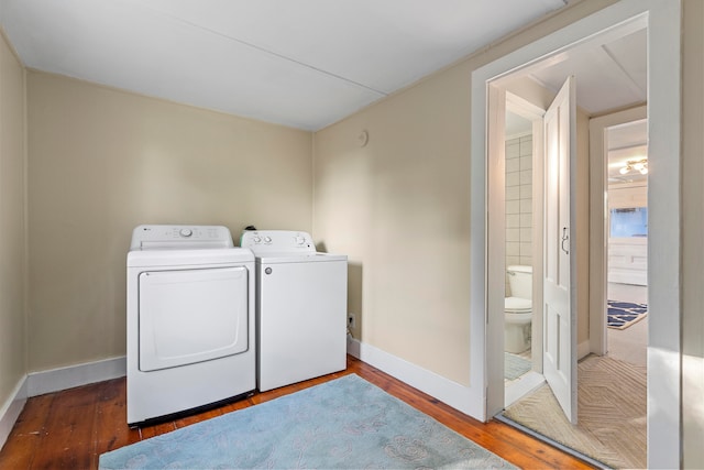 laundry area with hardwood / wood-style floors and independent washer and dryer