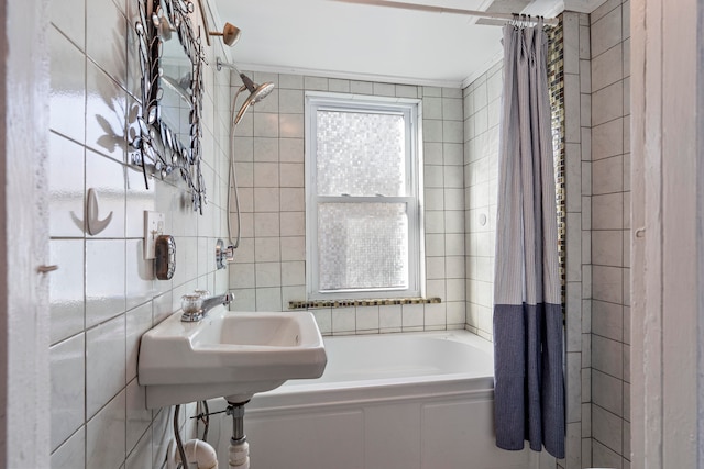 bathroom featuring ornamental molding, sink, and shower / tub combo with curtain