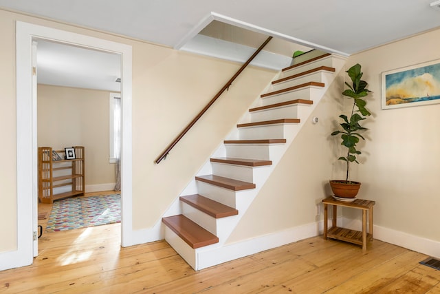 stairway with hardwood / wood-style flooring