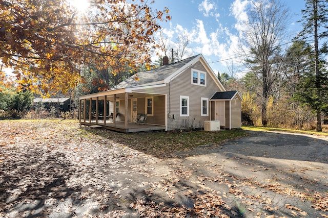 view of side of property with covered porch