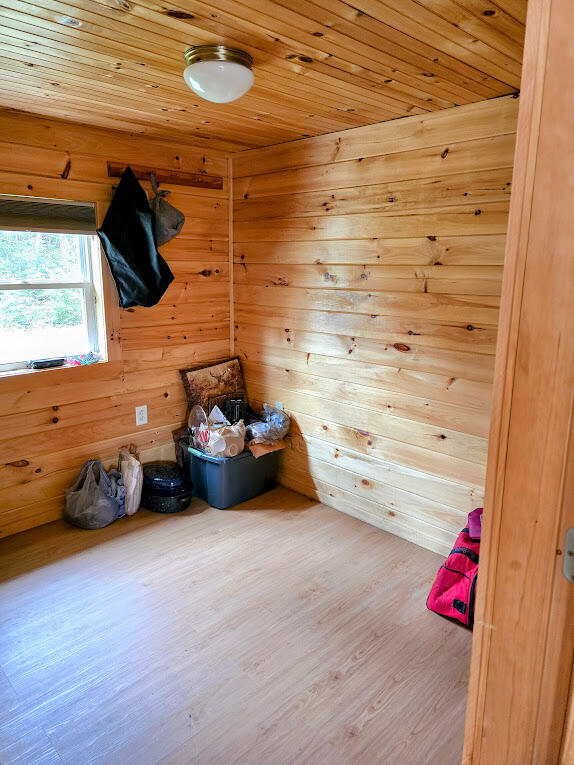 interior space with wood ceiling, wood walls, and wood-type flooring