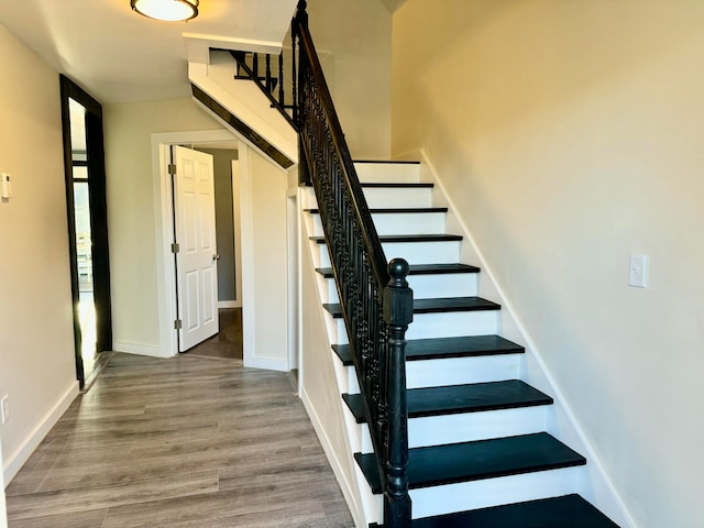 staircase featuring hardwood / wood-style floors