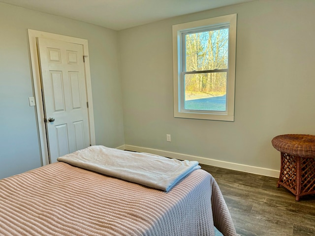 bedroom with dark wood-type flooring