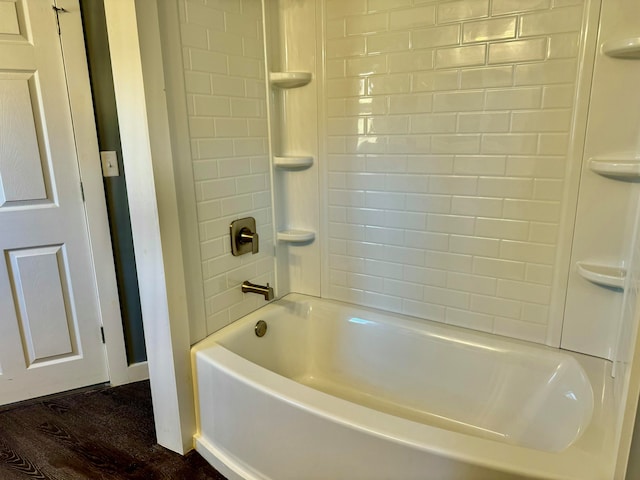 bathroom with tiled shower / bath combo and wood-type flooring