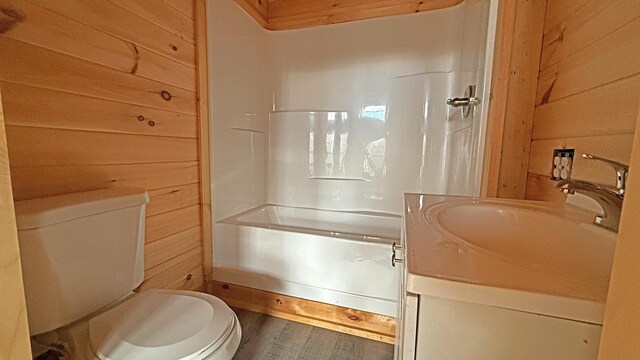 10 Bog Brook Way, Cutler, ME 04626 - full bathroom featuring toilet, vanity, shower / bath combination, wooden walls, and wood finished floors